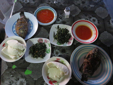 Fried bream fish, rape, tomato sauce and nshima