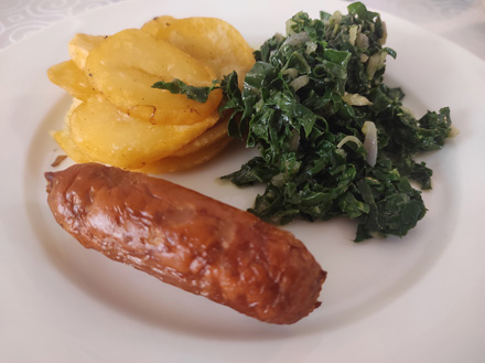 Sausage, fried potatoes and greens