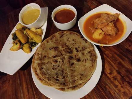 Goat stew, potato wedges and chapati